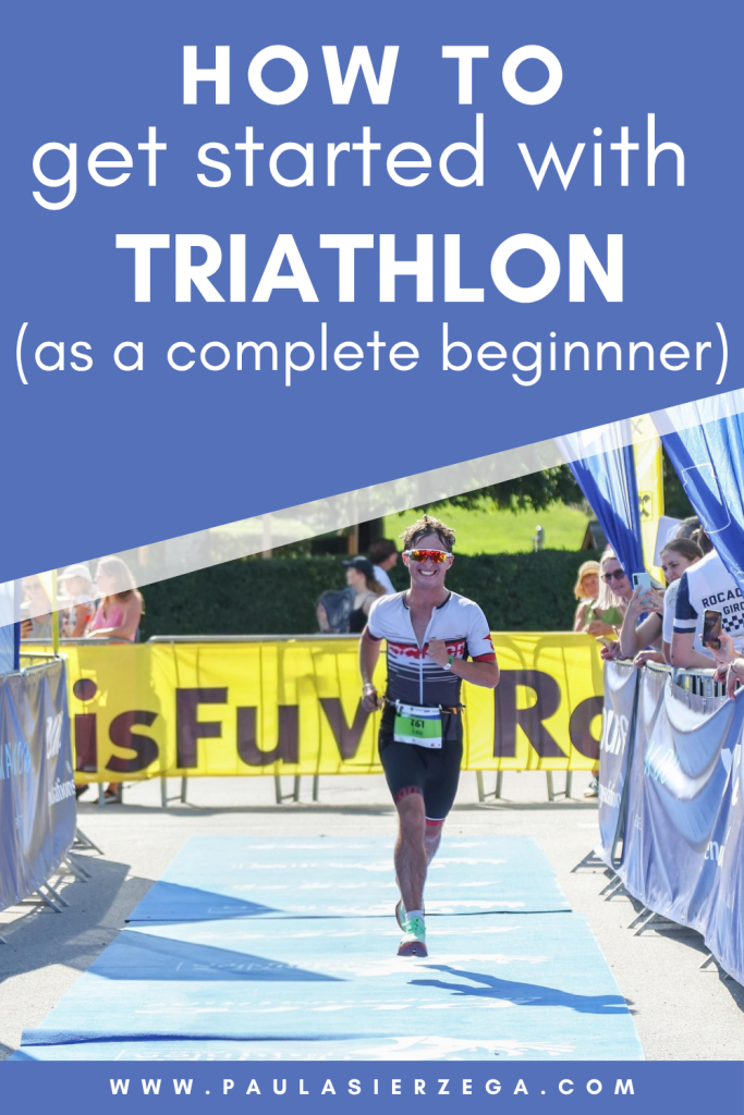Beginner triathlete entering the finisher chute of a sprint distance triathlon with text overlay “How to get started with triathlon (as a complete beginner)”.